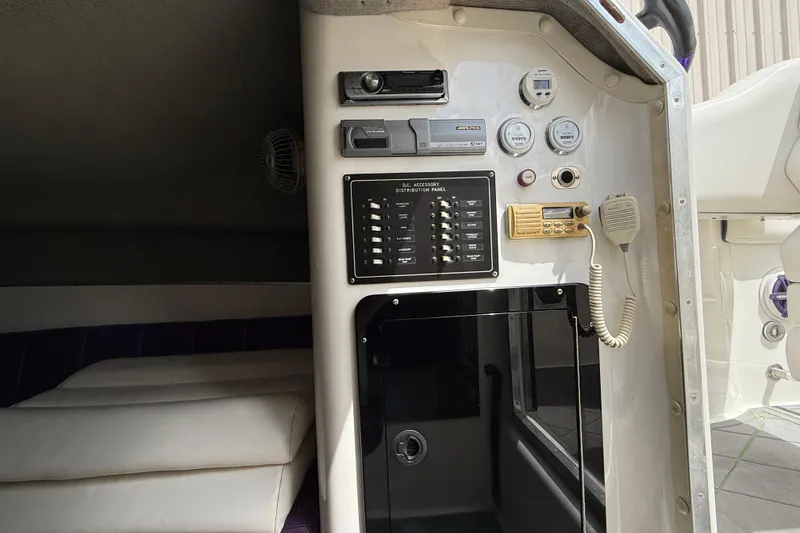 Slide: The Image of Control panel of a 1997 Powerplay Powerboats 33 Sport Deck with gauges and radio. - 14