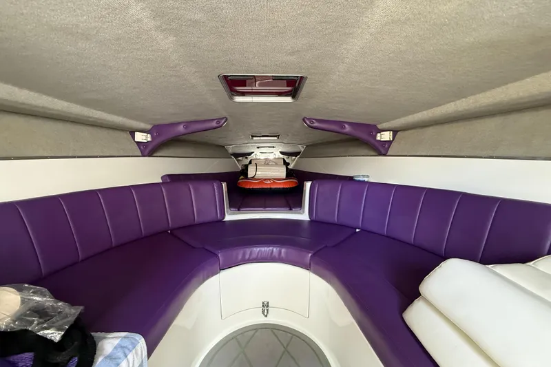 Slide: The Image of Interior of 1997 Powerplay Powerboats 33 Sport Deck with purple seating. - 15