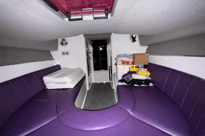 Slide: The Image of Interior of 1997 Powerplay Powerboats 33 Sport Deck with purple seating and storage items. - 16