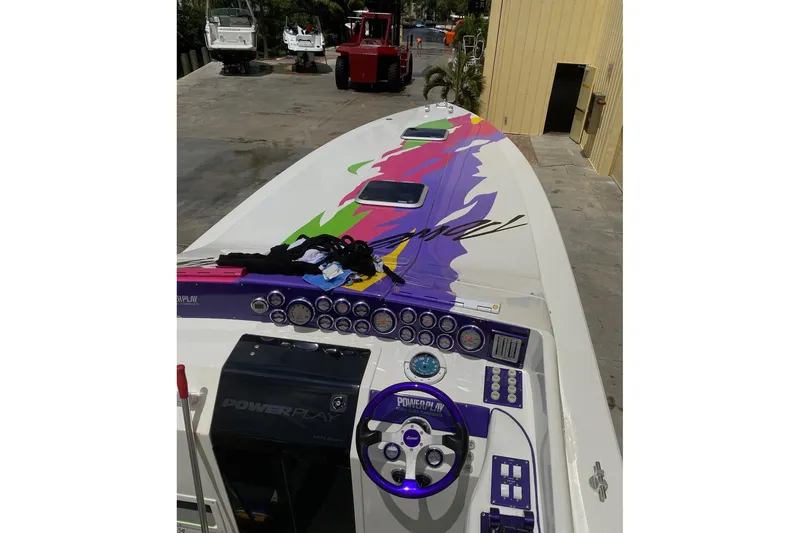 Slide: The Image of 1997 Powerplay Powerboats 33 Sport Deck with vibrant graphics and detailed dashboard. - 4