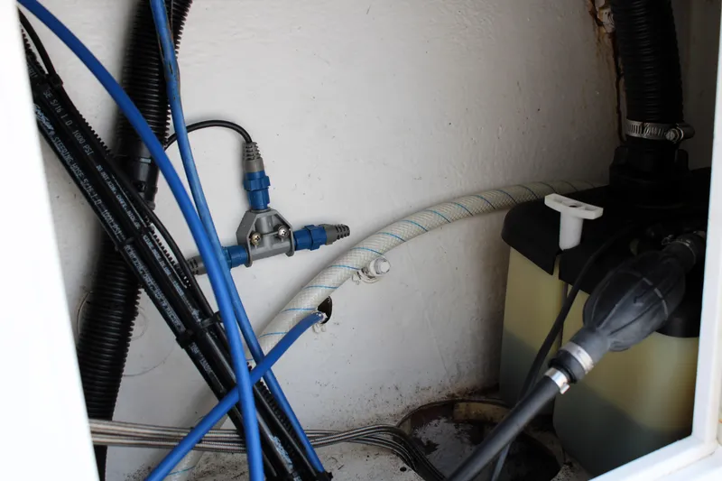 Slide: The Image of Interior view of a 2007 Renegade 29CC boat showing hoses and a fluid container. - 10