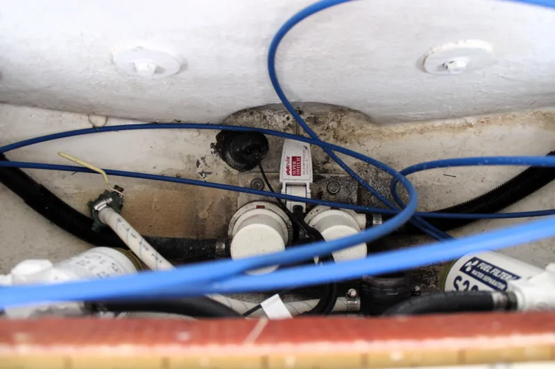 Slide: The Image of Engine compartment of a 2007 Renegade 29CC boat with visible wiring and components. - 11