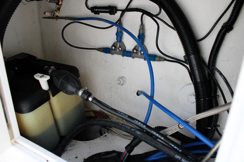 Slide: The Image of 2007 Renegade 29CC boat wiring and fluid system components in compartment. - 12