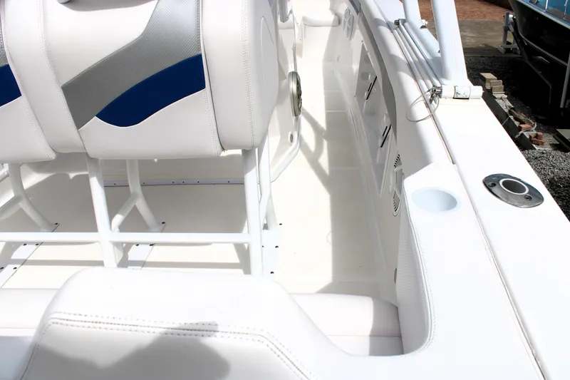 Slide: The Image of Interior of a 2007 Renegade 29CC boat, featuring white and blue seating. - 16