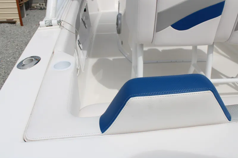 Slide: The Image of Interior of a 2007 Renegade 29CC boat with white and blue seating. - 17