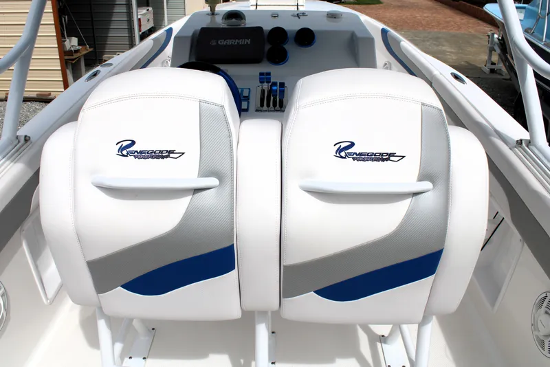 Slide: The Image of 2007 Renegade 29CC boat interior with white and blue seating, featuring Garmin equipment. - 18