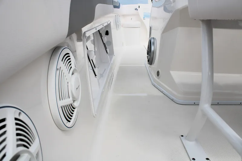 Slide: The Image of Interior view of a 2007 Renegade 29CC boat, featuring speakers and storage compartments. - 22