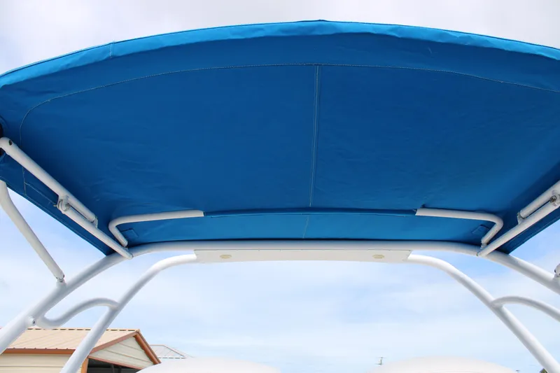 Slide: The Image of Blue canopy of a 2007 Renegade 29CC boat against a clear sky. - 23