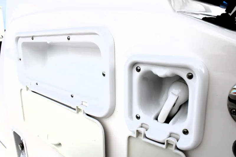 Slide: The Image of Close-up of a 2007 Renegade 29CC boat's white exterior compartment and handle. - 27
