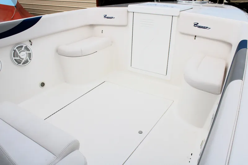 Slide: The Image of 2007 Renegade 29CC boat interior with white seating and storage compartments. - 29
