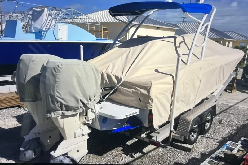 Slide: The Image of Covered 2007 Renegade 29CC boat on trailer, featuring dual outboard motors. - 3