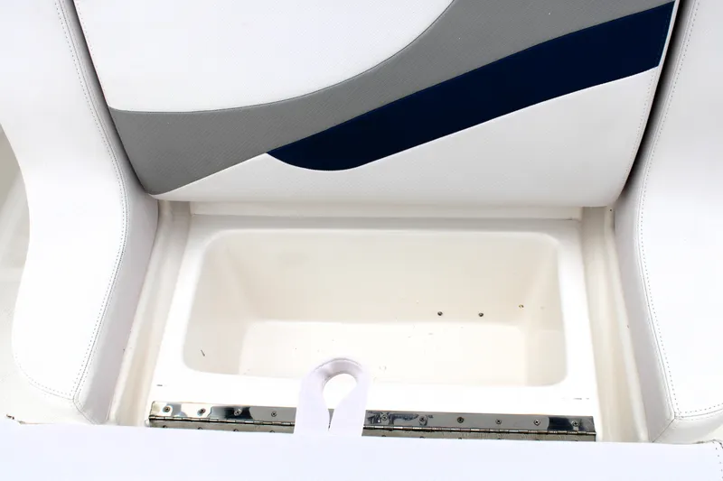 Slide: The Image of 2007 Renegade 29CC boat seat storage compartment, featuring white and gray upholstery. - 31