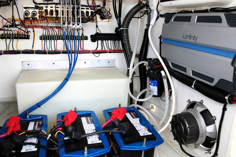 Slide: The Image of Electrical system and components inside a 2007 Renegade 29CC boat, featuring batteries and wiring. - 33