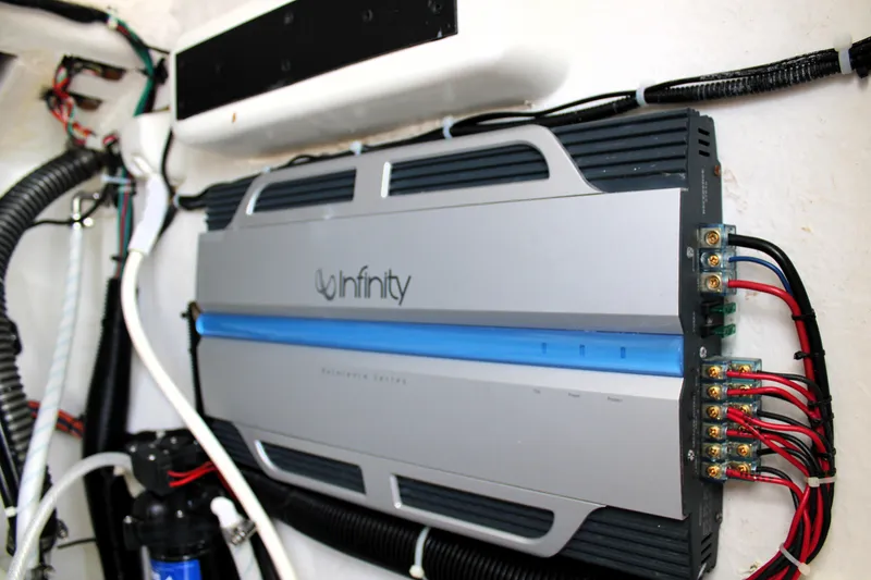 Slide: The Image of Infinity amplifier installed in a 2007 Renegade 29CC boat, showcasing wiring and connections. - 35