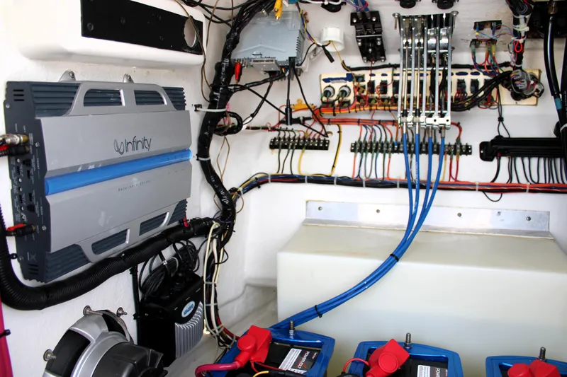 Slide: The Image of Electrical system setup in a 2007 Renegade 29CC boat, featuring Infinity amplifier and wiring. - 37