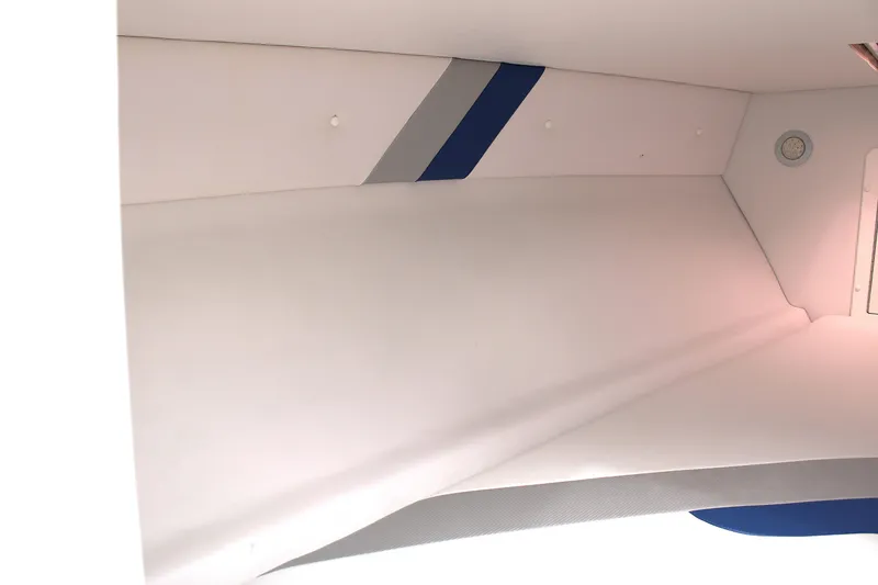 Slide: The Image of Interior view of a 2007 Renegade 29CC boat cabin with sleek white and blue design. - 42