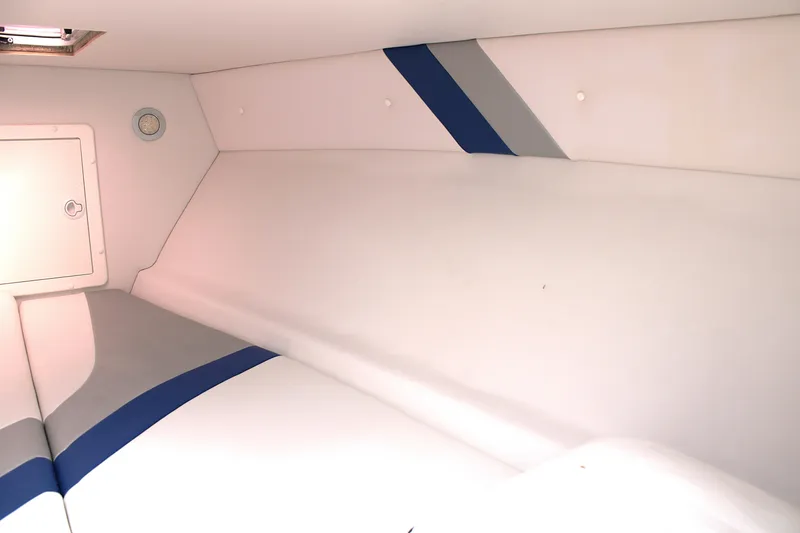 Slide: The Image of Interior cabin of 2007 Renegade 29CC boat with white and blue upholstery. - 43