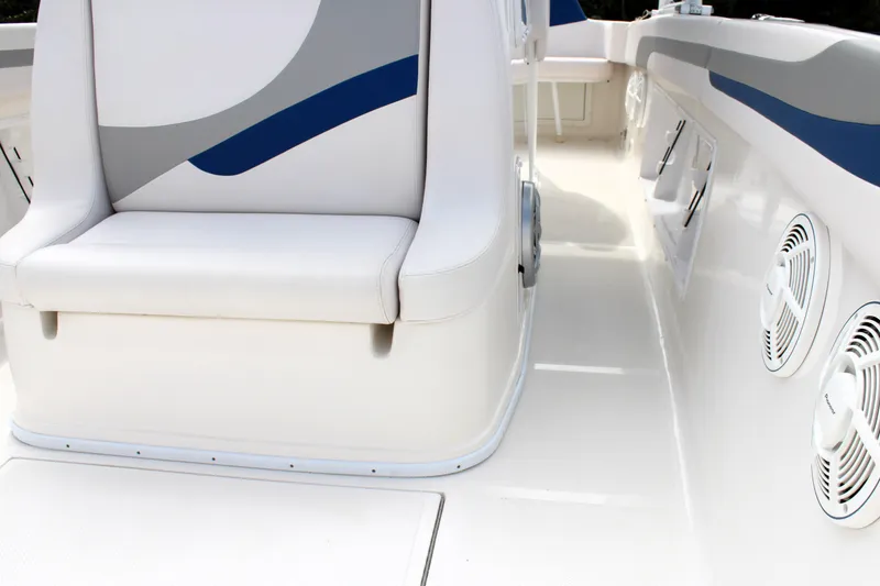 Slide: The Image of 2007 Renegade 29CC boat interior with white seating and blue accents. - 46