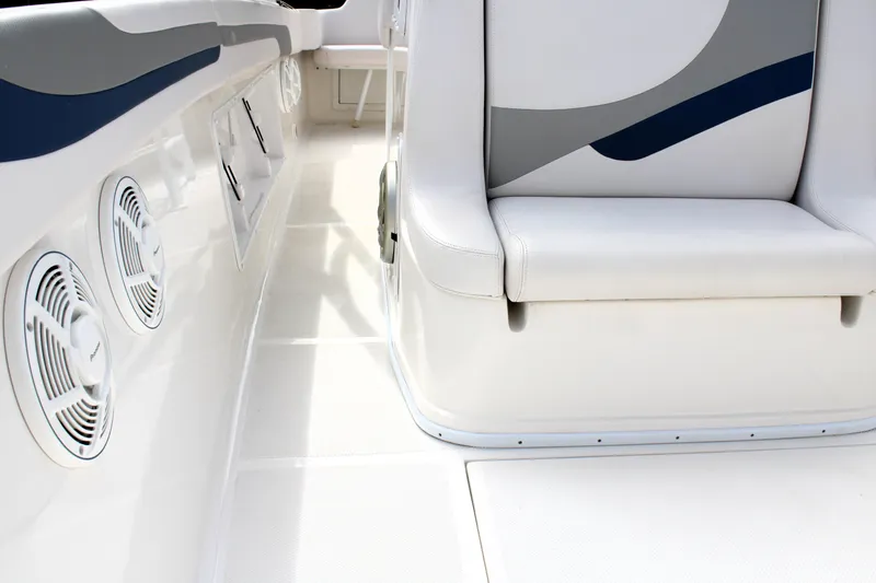 Slide: The Image of 2007 Renegade 29CC boat interior with white seating and built-in speakers. - 47