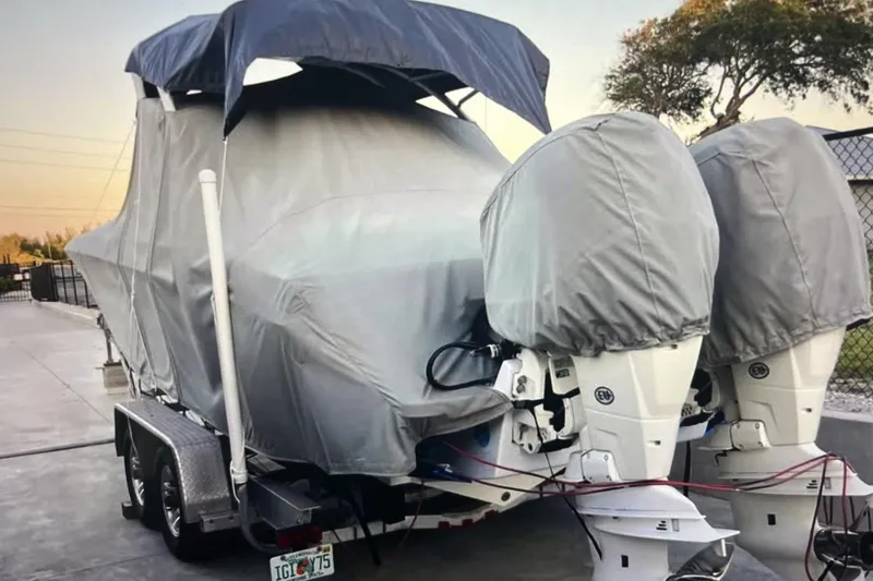 Slide: The Image of Covered 2007 Renegade 29CC boat on trailer with dual outboard motors. - 5