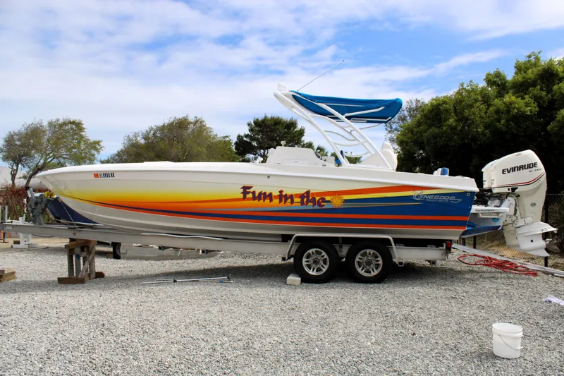 Slide: The Image of 2007 Renegade 29CC boat with colorful graphics on a trailer, parked outdoors. - 57