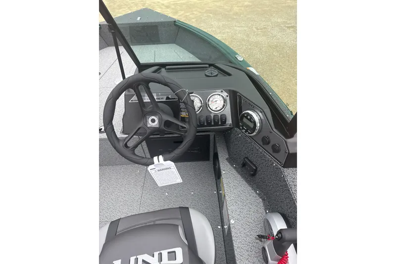 Slide: The Image of 2026 Lund 1700 Explorer Sport boat dashboard with steering wheel and instrument panel. - 11