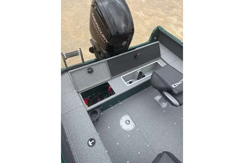 Slide: The Image of 2026 Lund 1700 Explorer Sport boat interior with Mercury engine and storage compartments. - 13