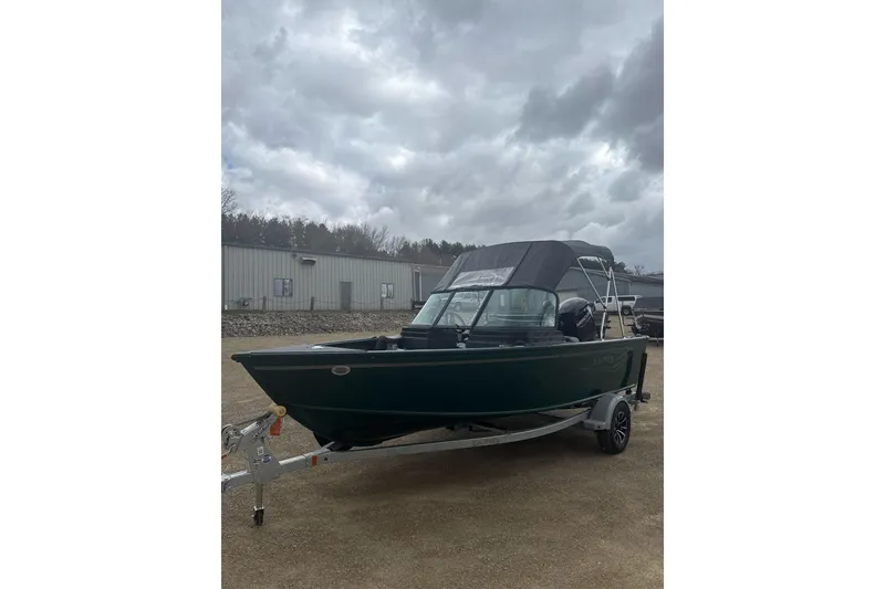 Slide: The Image of 2026 Lund 1700 Explorer Sport boat on trailer under cloudy sky. - 4