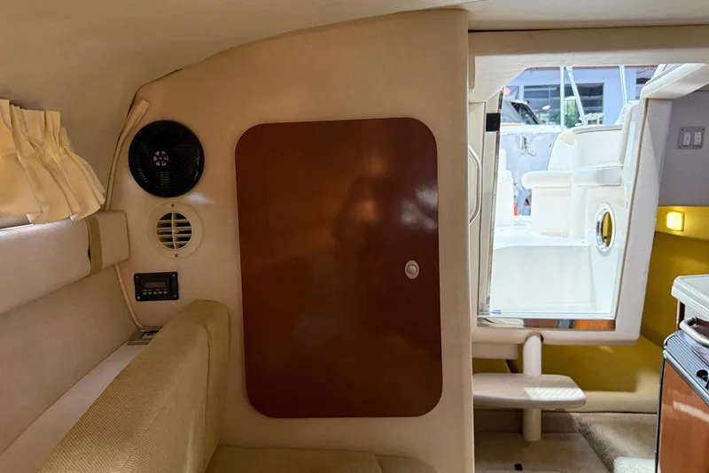 Slide: The Image of Interior of 2009 Sea Ray 240 Sundancer boat, featuring cabin seating and doorway. - 22