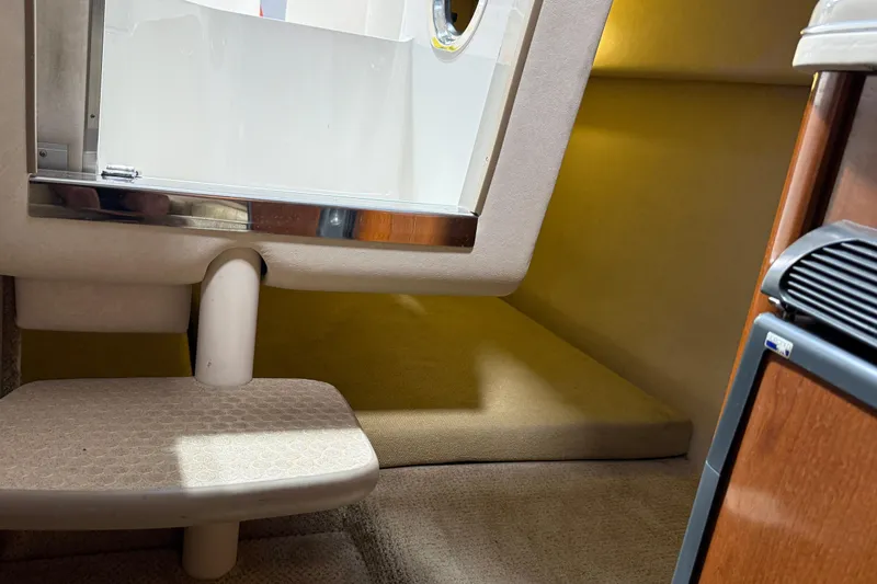 Slide: The Image of Interior cabin view of a 2009 Sea Ray 240 Sundancer boat, featuring a cozy seating area. - 23