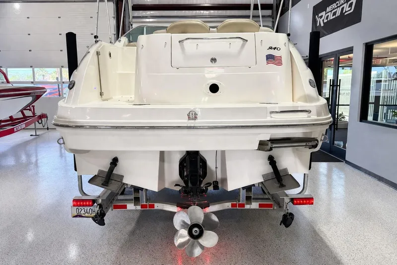 Slide: The Image of Rear view of 2009 Sea Ray 240 Sundancer boat in showroom. - 5