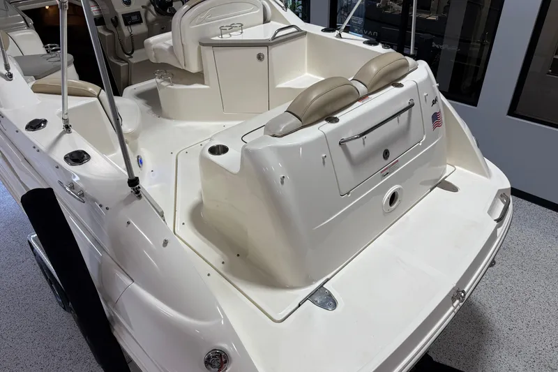Slide: The Image of 2009 Sea Ray 240 Sundancer boat interior with seating and control panel. - 10