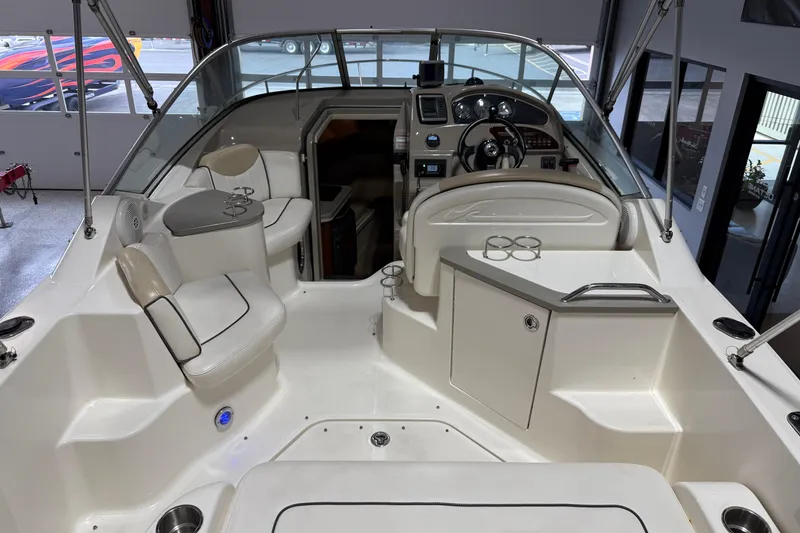 Slide: The Image of 2009 Sea Ray 240 Sundancer boat interior with seating and helm, showcasing modern design. - 12