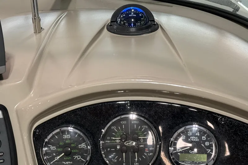 Slide: The Image of Dashboard of a 2009 Sea Ray 240 Sundancer with compass and gauges. - 15