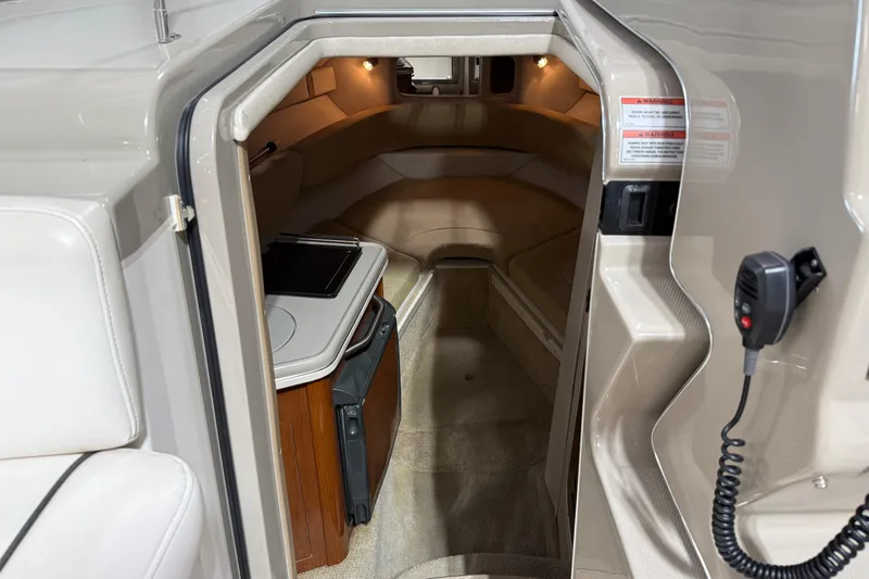 Slide: The Image of Interior cabin of 2009 Sea Ray 240 Sundancer boat, featuring cozy seating and compact amenities. - 16