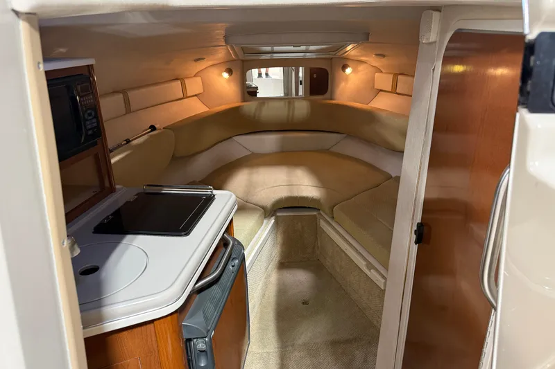 Slide: The Image of Interior of 2009 Sea Ray 240 Sundancer boat with cozy seating and kitchenette. - 17