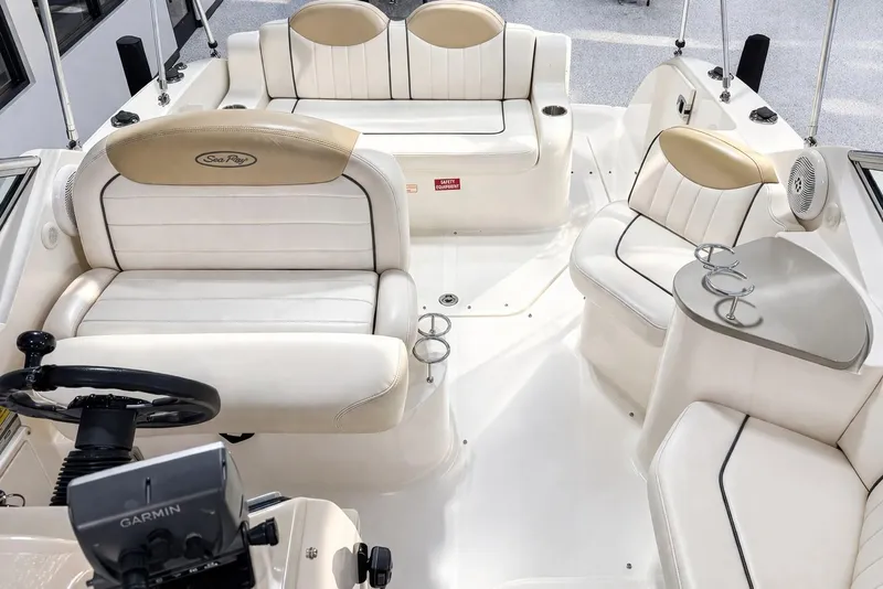 Slide: The Image of Interior of a 2009 Sea Ray 240 Sundancer boat with white seating and Garmin equipment. - 26