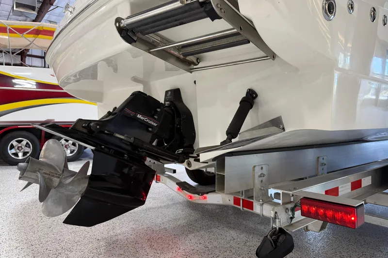Slide: The Image of 2009 Sea Ray 240 Sundancer boat with MerCruiser engine on trailer in garage. - 6