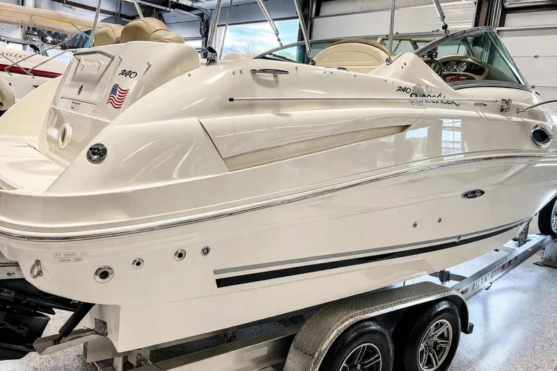Slide: The Image of 2009 Sea Ray 240 Sundancer boat on trailer in showroom. - 7