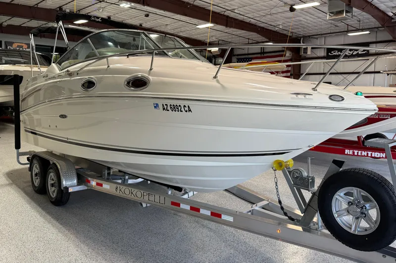 Slide: The Image of 2009 Sea Ray 240 Sundancer boat on trailer in indoor showroom. - 8