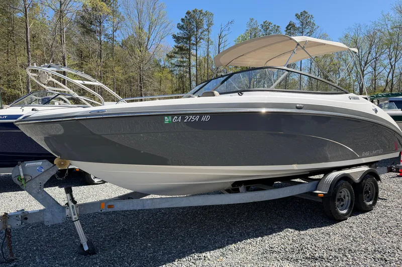 The Image of 2016 Yamaha Boats 242 Limited S on trailer, parked outdoors. - 1