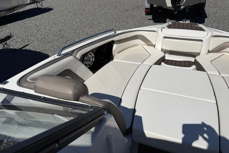 Slide: The Image of 2016 Yamaha Boats 242 Limited S interior with white seating and speaker detail. - 10