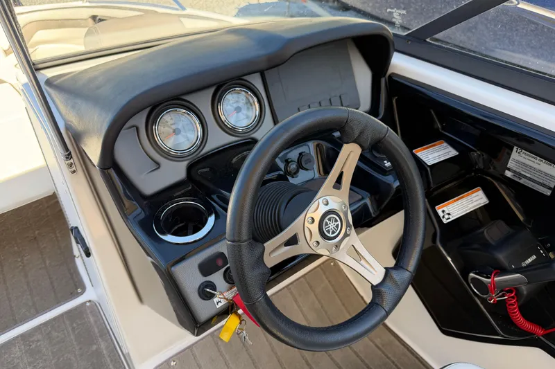 Slide: The Image of 2016 Yamaha Boats 242 Limited S dashboard with steering wheel and gauges. - 11