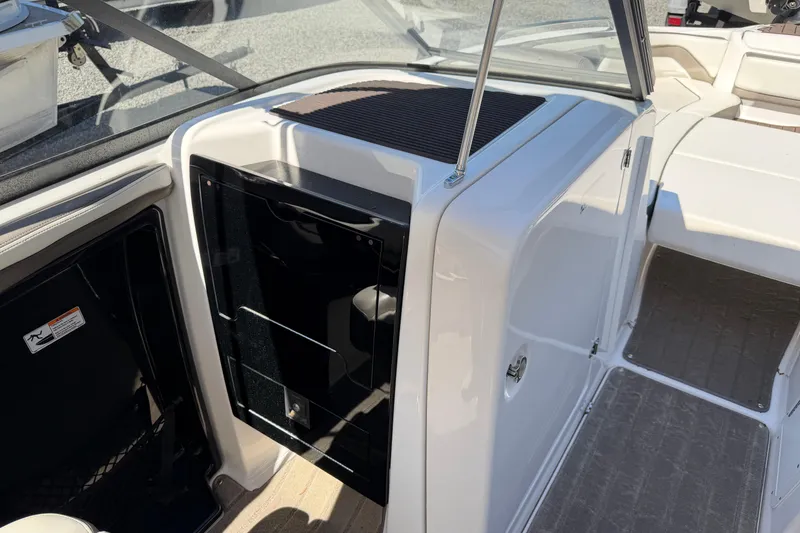 Slide: The Image of 2016 Yamaha Boats 242 Limited S interior cockpit with storage compartment and seating area. - 19