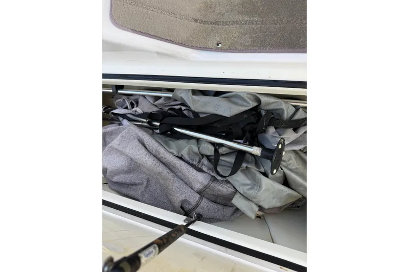 Slide: The Image of Storage compartment of a 2016 Yamaha Boats 242 Limited S with equipment and cover. - 22