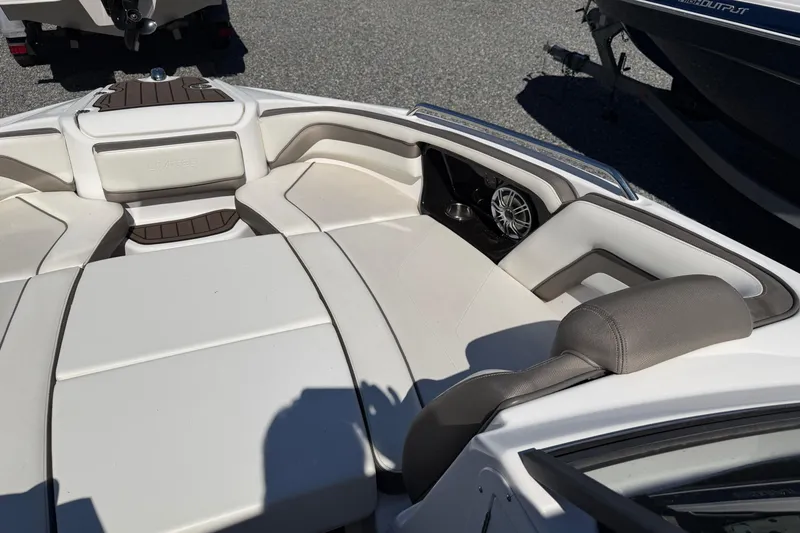 Slide: The Image of 2016 Yamaha Boats 242 Limited S interior with white seating and speaker system. - 9