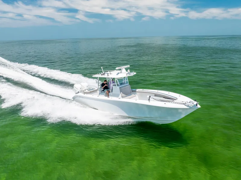 Slide: The Image of 2018 Yellowfin 32 Offshore boat cruising on open sea. - 12