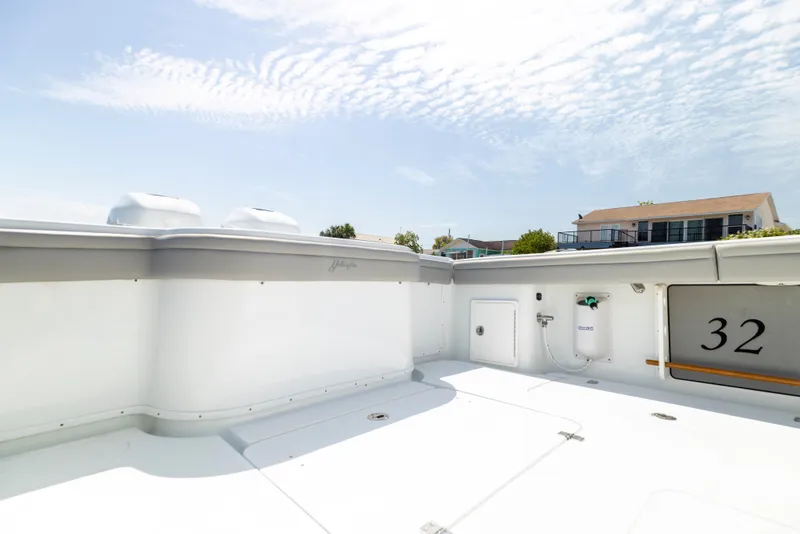 Slide: The Image of Deck of a 2018 Yellowfin 32 Offshore boat under sunny skies. - 19