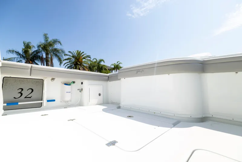 Slide: The Image of 2018 Yellowfin 32 Offshore boat deck with palm trees in background. - 20