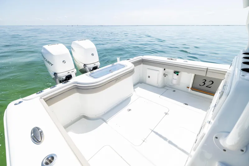 Slide: The Image of 2018 Yellowfin 32 Offshore boat with twin outboard engines on calm water. - 23